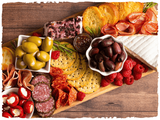 A Charcuterie board with meat, cheese and vegetables