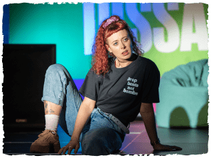 Woman with red hair sat slouched 