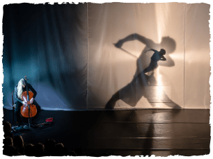 dancer in lunge position, silhouette behind