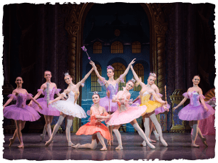 A group of performers in pink and yellow ballet outfits