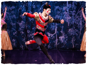 A performer dancing in red and black