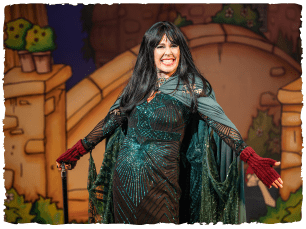 Lucy Benjamin in a Claudia winkleman style wig and dark cloak