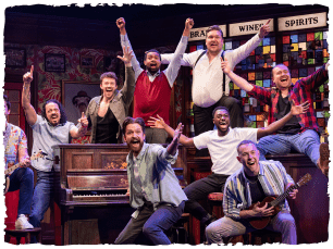Men celebrating around a piano