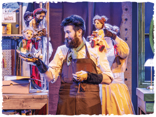 Man holding lots of puppets