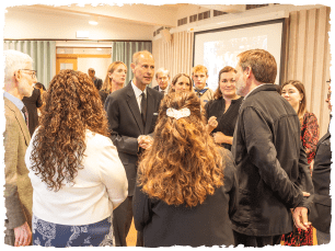 HRH talking with a group of people in the River Room