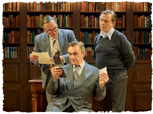 3 men all looking at a piece of paper