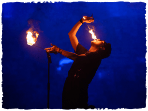 A man swallowing sticks of fire