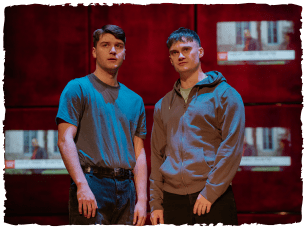 two actors stood next to each other looking at the camera