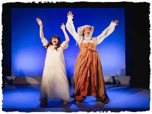 Twoa ctors with their arms in the air