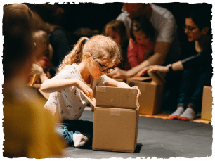 Young girl peering inside box