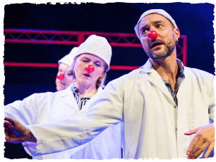 Actors in white doctor jackets with clown nose