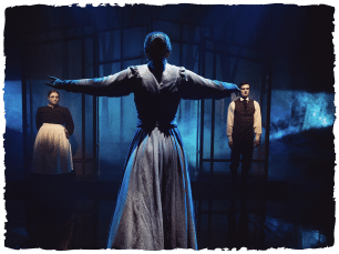 Woman with arms extended, a man and woman stood in front of her