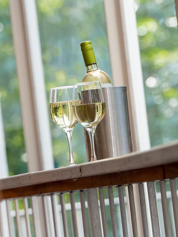 A bottle of wine and two glasses sit on a ledge in the theatre.