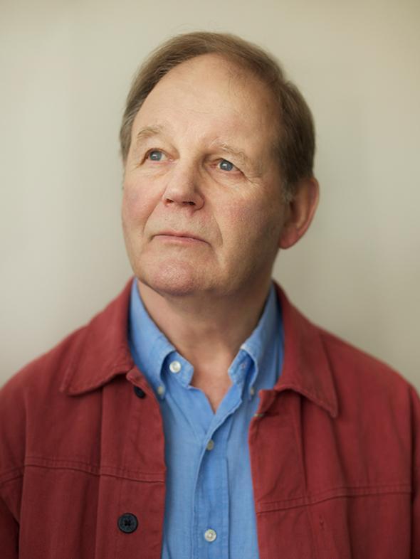 Michael Morpurgo in a blue shirt and red jacket