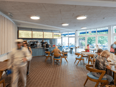 A cafe with people sitting at tables