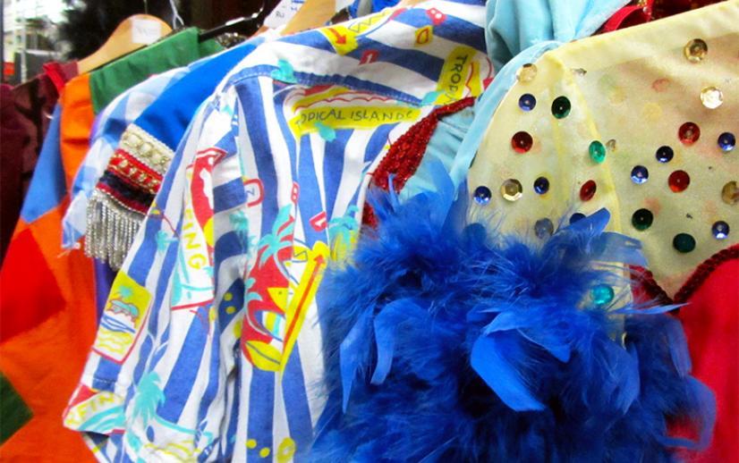 A selection of bright and colourful pantomime costumes on a rail