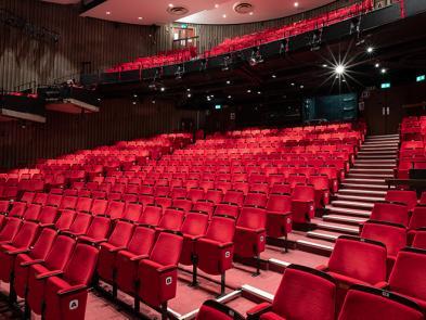 Image of red auditorium seats.