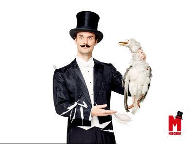 A magician appears holding what looks like a dead seagull.