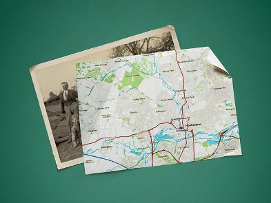 A dark green background with a sepia tone postcard and a map overlaid on top.