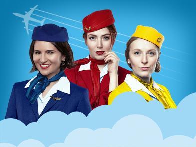 Three women, one in blue, one in red and one in yellow air hostess uniforms behind some clouds.