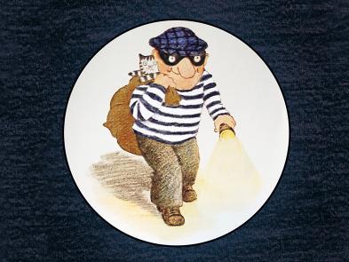 A cartoon image of a man in a striped jumper, goggles and hat. He holds a torch in one hand and the other holds a swag bag over his shoulder with a cat inside.