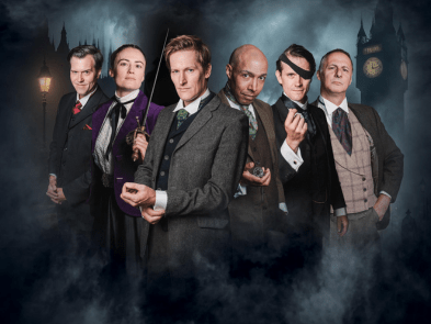 A man in a black coat and tophat looks away next to Big Ben and a stream train