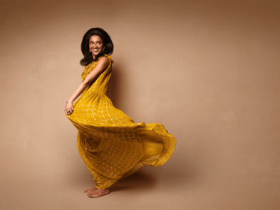 Sindhu in yellow dress, twirling