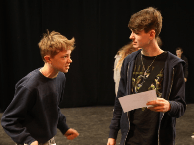 Two boys debating a script together