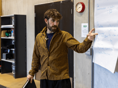 Nathan Crossan-Smith stood up pointing