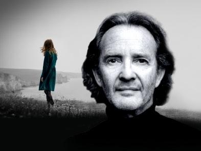 Black and white image, Anton Lesser at front, with woman in distance on beach