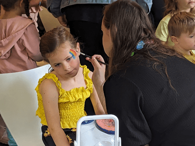 A child getting rainbow face paint