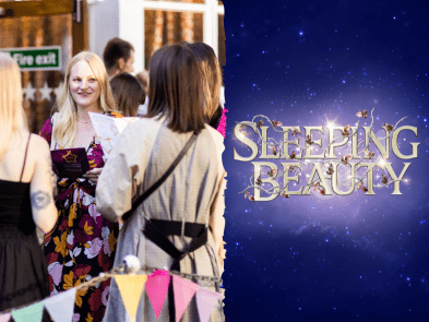 Showgoers group of people, with Macbeth poster next to it