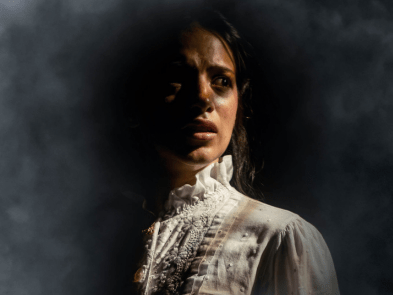 A scared woman in shadows