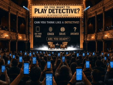 People in an auditorium holding phones up