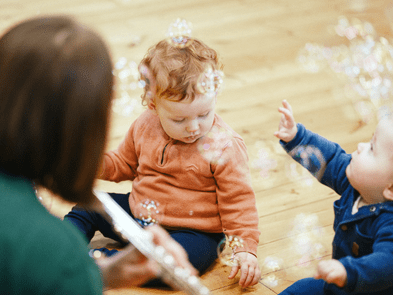 woman playing instrument to baby