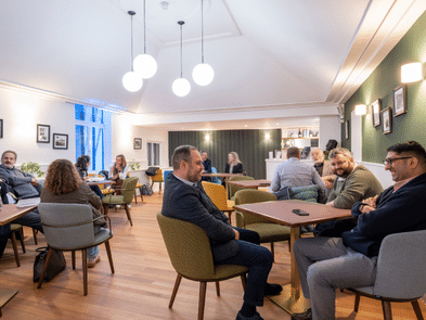 People sitting and chatting in the recently refurbished Vanbrugh Room