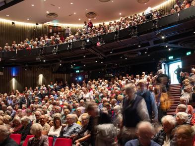 Image of the auditorium filled with audience members