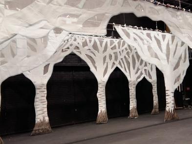 A stage with white trees made out of cloth