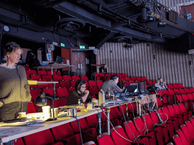 joanna read directing, standing in the stalls with a headset on