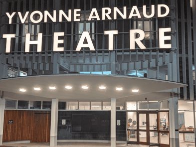 The outside of the theatre with a sign 